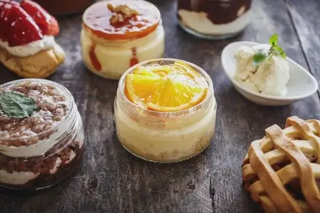 Assortment of puddings in glass jars